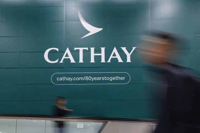 MTR passengers walk past a Cathay Pacific advertisement in an MTR station, in Hong Kong, China, March 11, 2026. Photo by Reuters