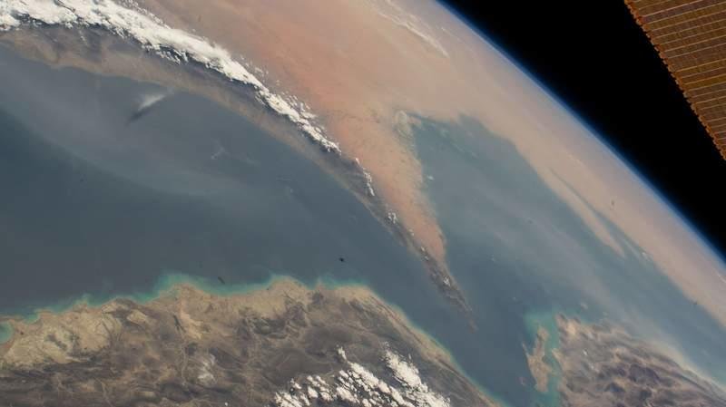 A satellite image, captured by NASA, shows the Strait of Hormuz, which connects the Gulf of Oman (L) with the Persian Gulf (R) and separates Iran (below) from the countries of the Arabian Peninsula—Oman, the United Arab Emirates, and Qatar. -/Nasa/dpa