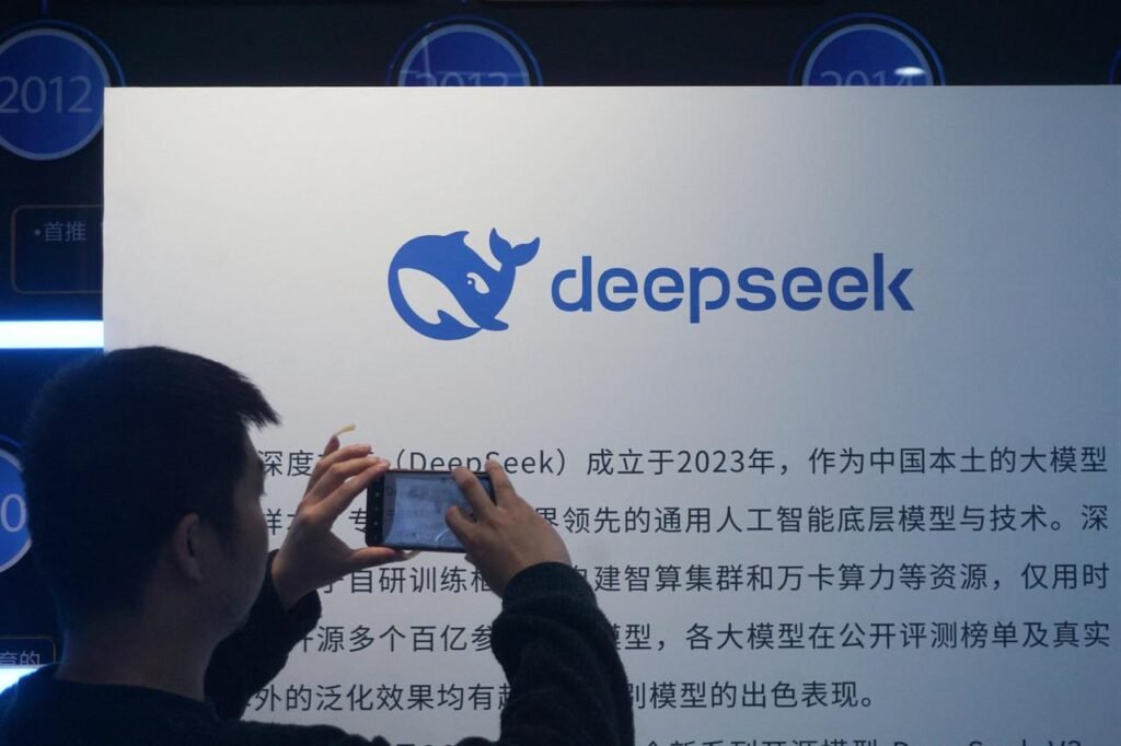 A man takes photos of a DeepSeek display at a shopping mall in Hangzhou, Zhejiang province, China, April 23, 2026. (AFP Photo)