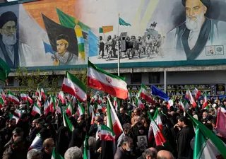 Mourners carry Iranian flags in Tehran on April 1, 2026 during a funeral procession for Alireza Tangsiri, head of Iran's Islamic Revolutionary Guard Corps Navy, and others killed in Israeli strikes (AP)