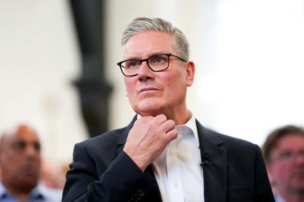 A close-up view of a man in a dark suit and white shirt.