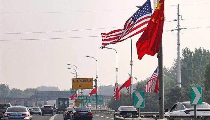 National flags of China and the United States flutter on a road, ahead of the US President Donald Trumps state visit to China, in Beijing, China, May 13, 2026. — Reuters