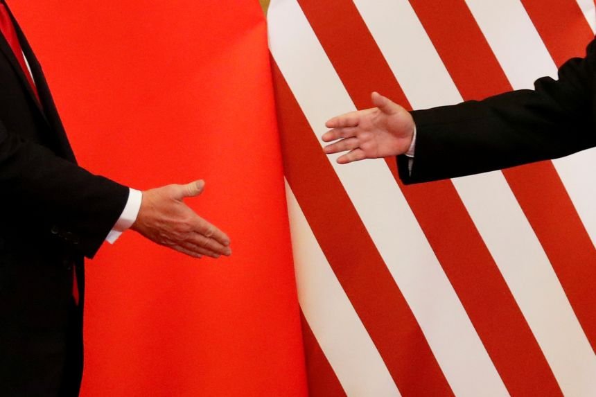 US President Donald Trump and China's leader Xi Jinping shake hands at the Great Hall of the People in Beijing, China, November 9, 2017.