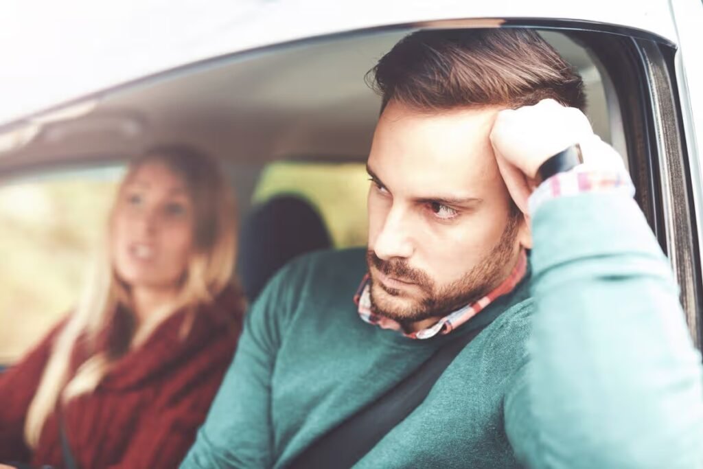 Frustrated car driver. Young couple having a problem with navigation during their journey with a car, missed road. Bad relationship, discussions between man and woman