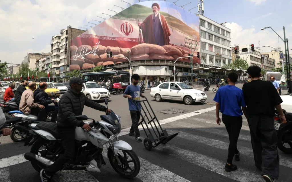 Commuters drive past a large billboard depicting Iran's Supreme Leader Ayatollah Mojtaba Khamenei on a street in Tehran on April 20, 2026. Iran insisted it has no plan to attend a new round of negotiations with the United States on April 20, as uncertainty grows over a push to stop the Middle East war from resuming. The US president said he was sending negotiators to Pakistan for talks on ending the war that engulfed the region and rattled global markets, while repeating threats to attack Iran's energy infrastructure if it did not make a deal.