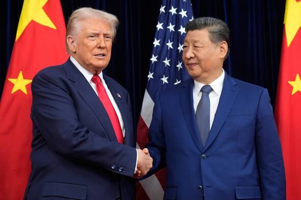 FILE - President Donald Trump, left, and Chinese President Xi Jinping shake hands before their meeting at Gimhae International A