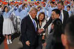 President Donald Trump talks during an arrival ceremony Wednesday, May 13, 2026, at Beijing Capital International Airport in Beijing, with Eric Trump, right.