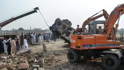 A crane removes a burned armored vehicle from a damaged police checkpost site following a car bombing attack by militants in the Fateh Khel area of Pakistan's Bannu. (AFP)