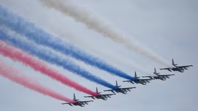 Russian Air Force Su-25 jets fly over Red Square leaving trails of smoke in the colors of the Russian state flag during the Victory Day military parade in Moscow. (AP)