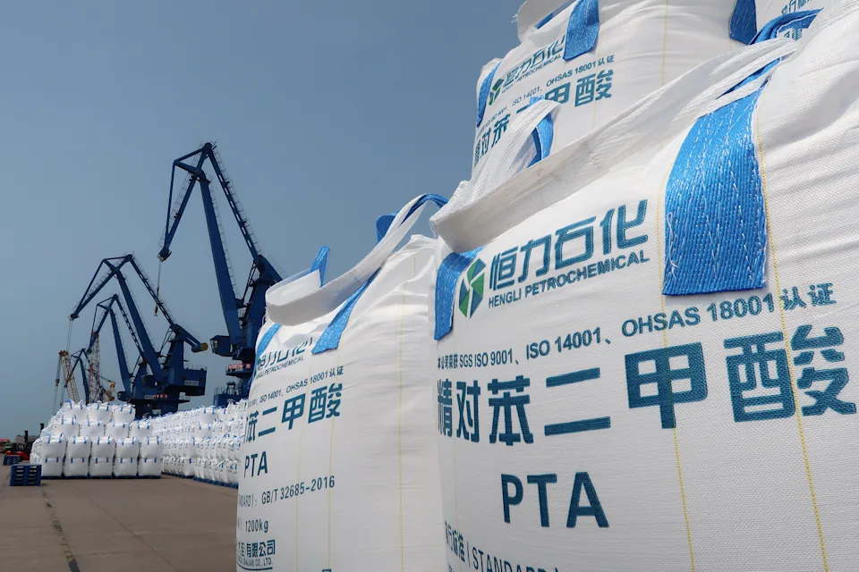Sacks of polyester-making chemicals, waiting to be shipped, are seen at Hengli Petrochemical's new refining, petrochemical complex at Changxing island in Dalian, Liaoning province, China July 16, 2018. Picture taken July 16, 2018. REUTERS/Chen Aizhu