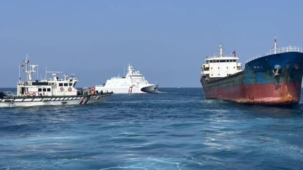 Two Taiwan Coast Guard personnel boarding a Togo-flagged cargo ship in waters off Penghu, Taiwan