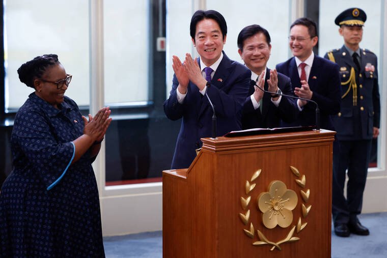 ANN WANG / REUTERS
                                Taiwan President Lai Ching-te holds a news conference at Taoyuan International Airport in Taiwan after returning from the southern African nation of Eswatini today. Lai thanked Deputy Prime Minister of Eswatini Thulisile Dladla, left, for flying back to Taiwan with him and the Taiwanese delegation.