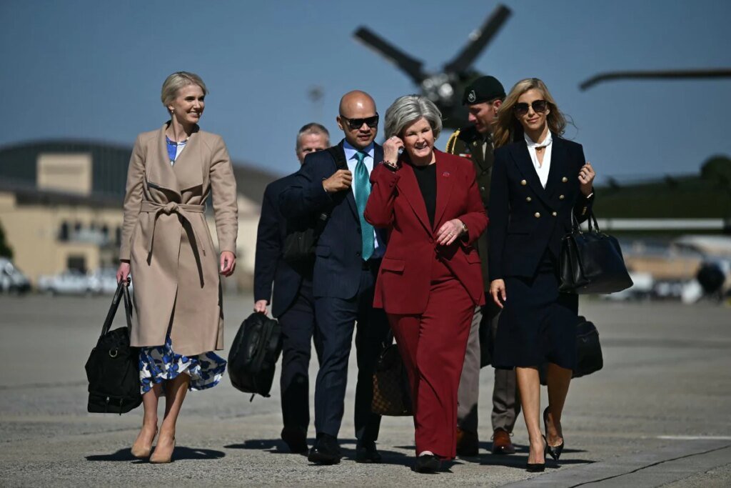 Presidential aide Natalie Harp, White House Chief of Staff Susie Wiles and newly appointed White House Press Secretary Katie Zacharia join US President Donald Trump boarding Air Force One at Joint Base Andrews, Maryland on October 13, 2026.