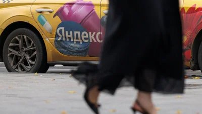 A woman walks past a Yandex-branded car in Moscow, Russia, October 13, 2026. REUTERS/Ramil Sitdikov (REUTERS)
