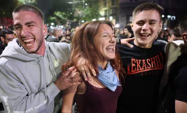 Youngsters celebrate after Aleksandar Vucic, leader of the right-wing Serbian Progressive Party (SNS) conceded defeat in the parliamentary election in Belgrade, Serbia, Sunday, Oct. 25, 2026. (AP)